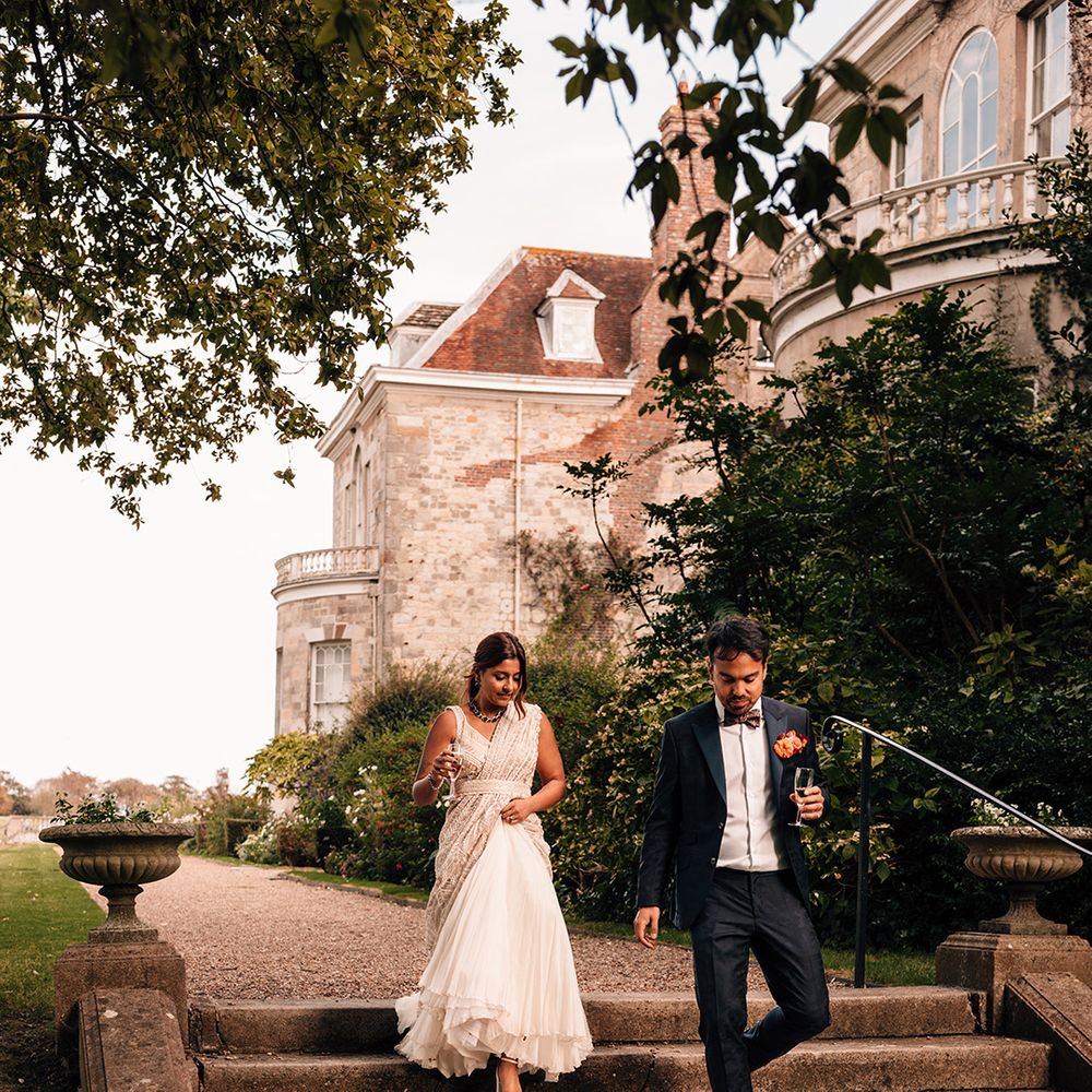 Candid couple portrait of bride and groom walking down the steps