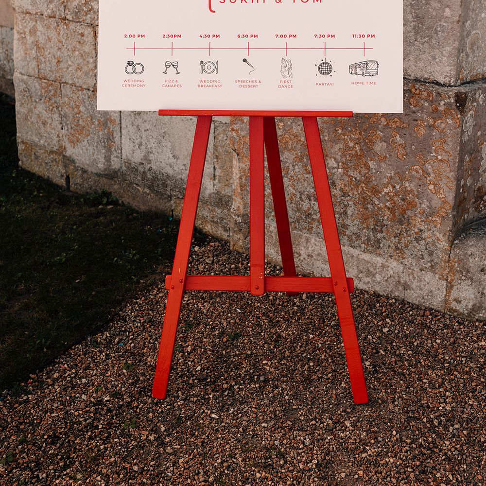 red-and-cream-wedding-welcome-sign-with-order-of-the-day