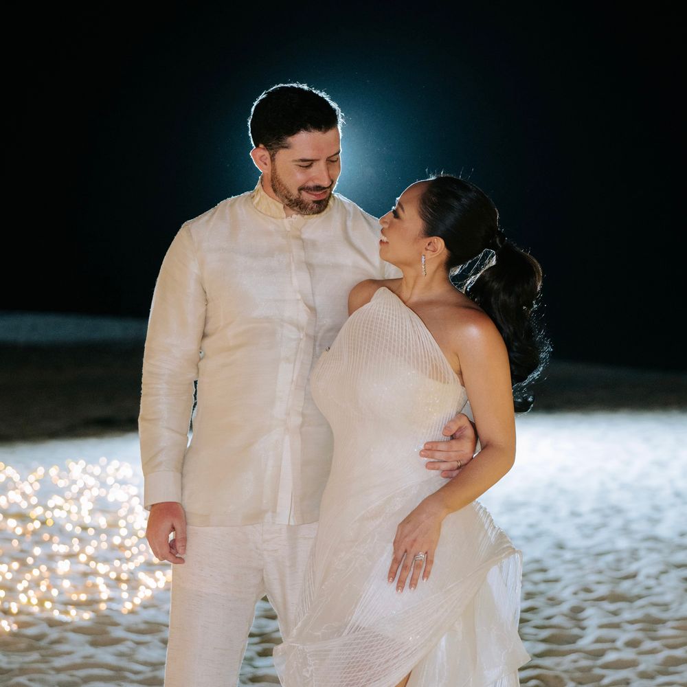bride-in-sparkly-wedding-reception-dress-with-groom-on-beach