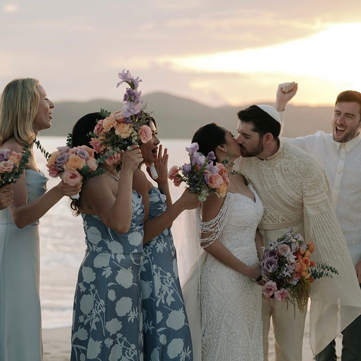 wedding-guests-cheer-as-couple-kiss
