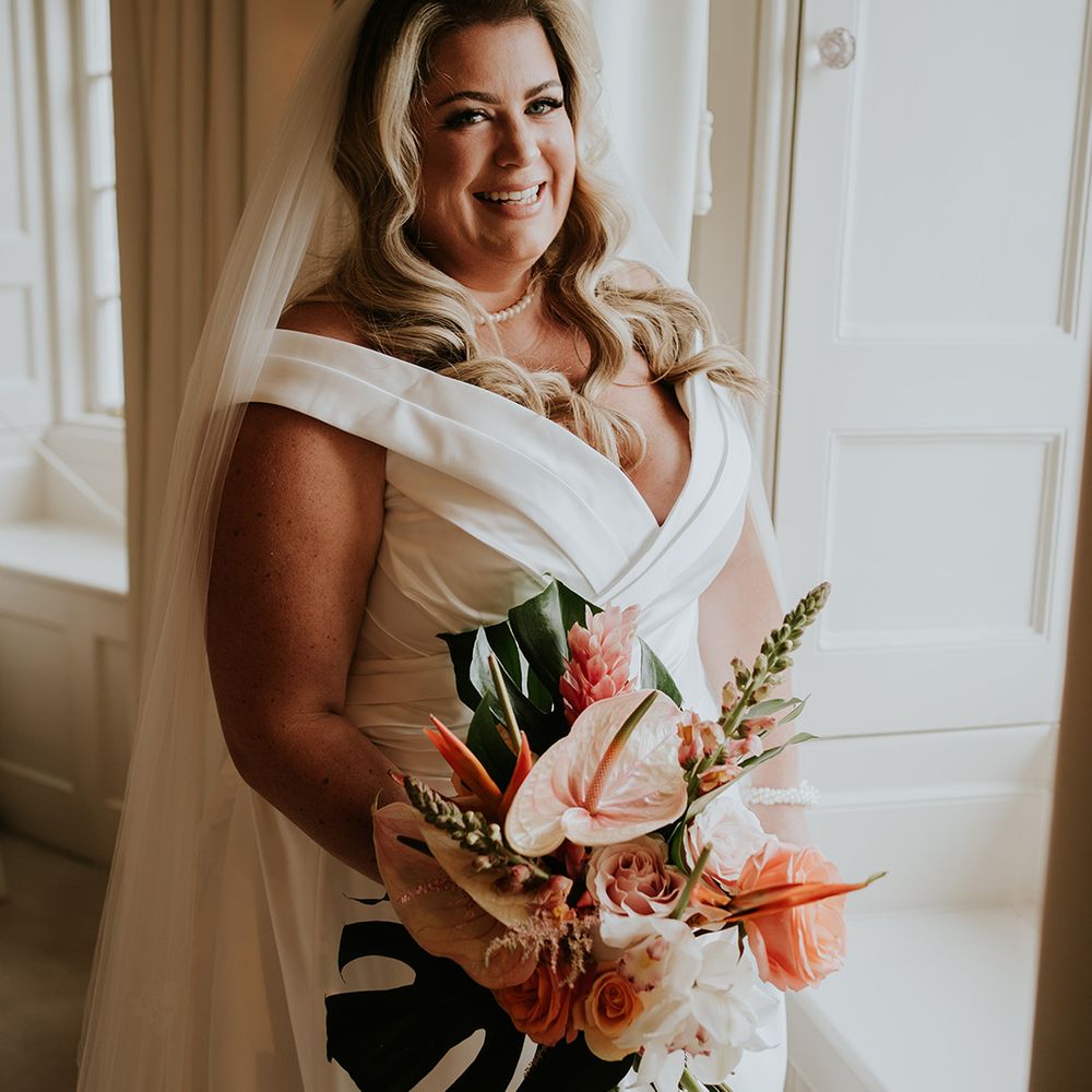 bride-in-off-the-shoulder-wedding-dress-carrying-tropical-wedding-bouquet-with-anthuriums