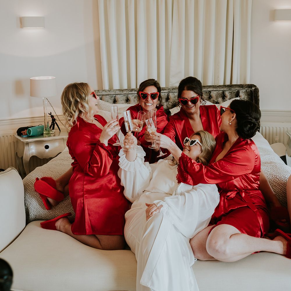 bridesmaids-wearing-red-pyjamas-drinking-with-bride