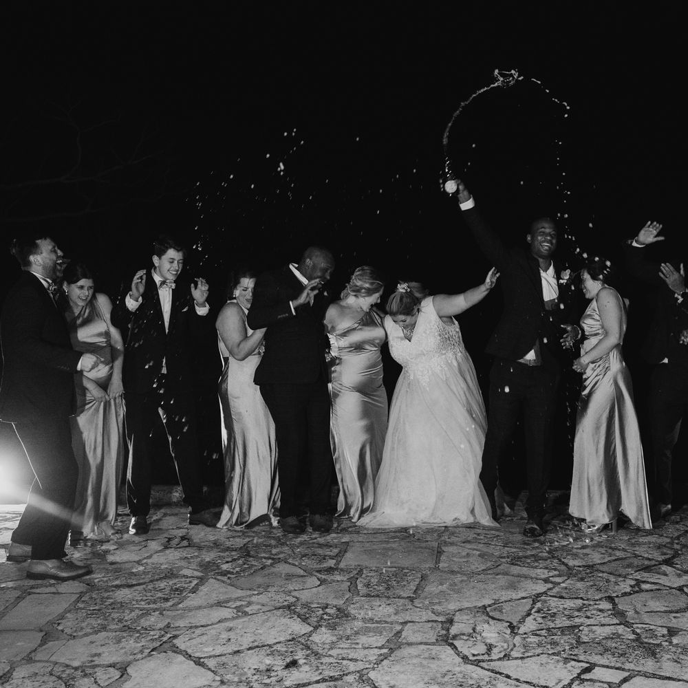 champagne-spray-group-wedding-party-photo