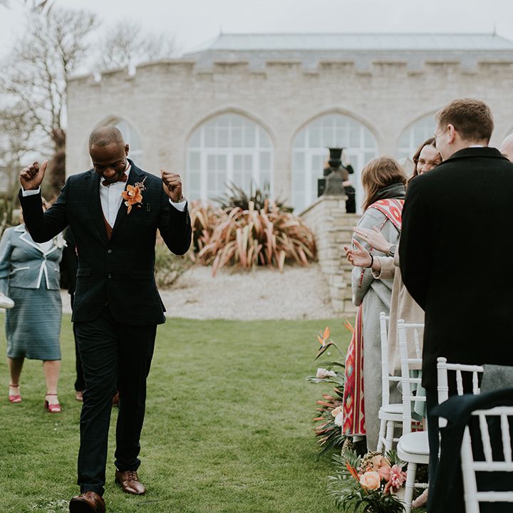 groom-celebrating-walking-down-the-aisle