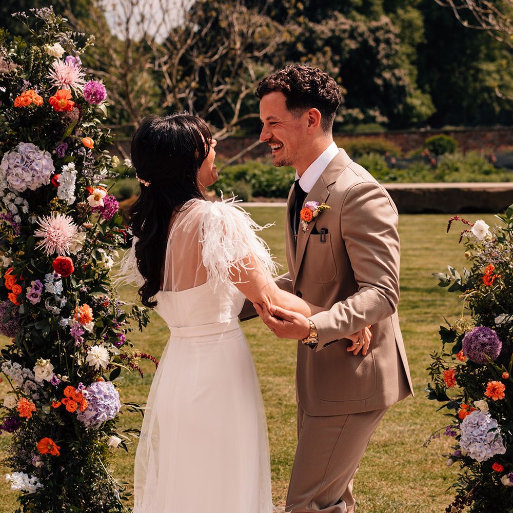 groom-in-brown-wedding-suit-and-bride-in-feather-wedding-dress