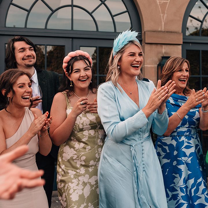 wedding-guests-applaud-married-couple