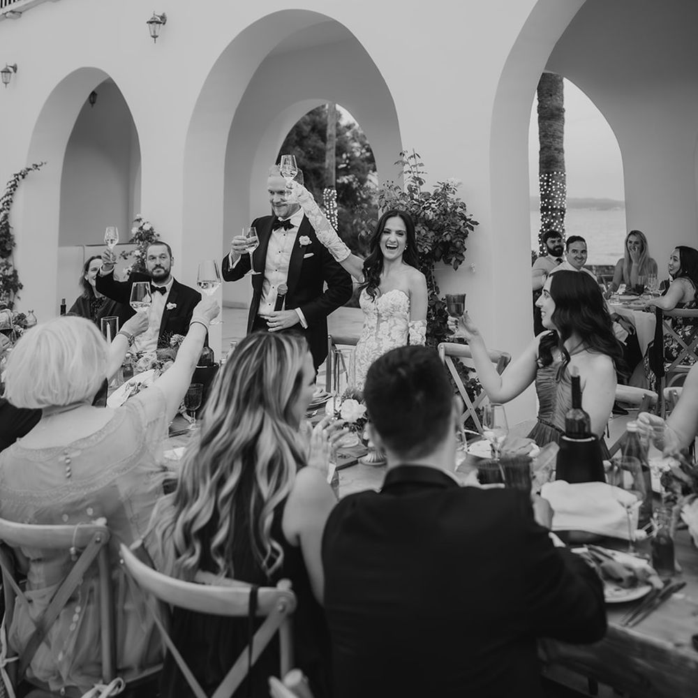 black-and-white-photo-of-bride-and-groom-delivering-wedding-speeches