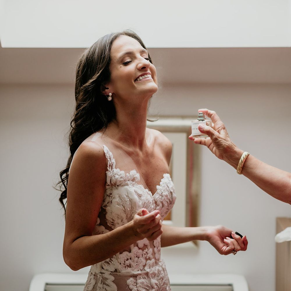 bride-in-floral-wedding-dress-gets-perfume-sprayed-on-her