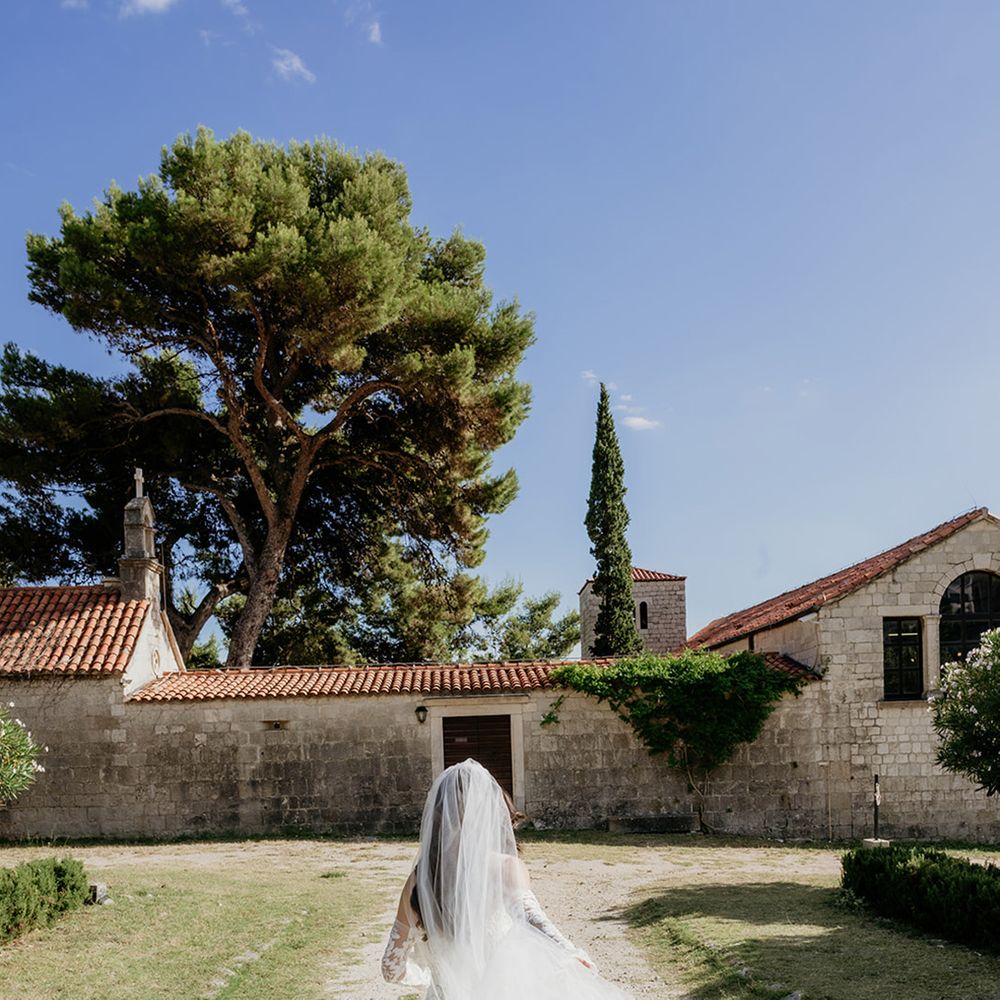 bride-wearing-cathedral-length-wedding-veil-running-around-venue