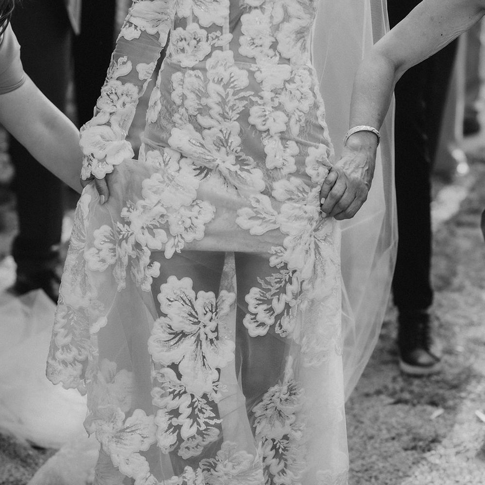 bride-wearing-pearl-jimmy-choo-and-floral-wedding-dress