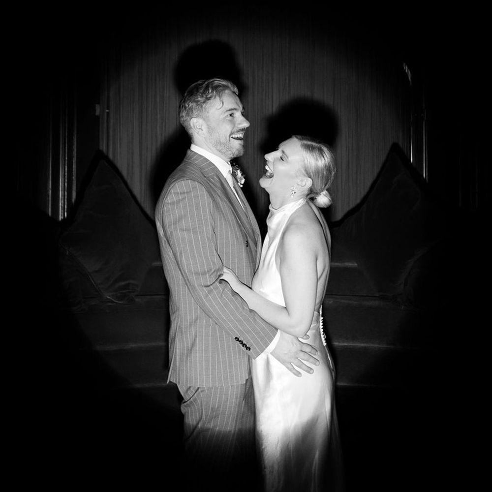 black-and-white-couple-portrait-of-couple-with-curtain-backdrop