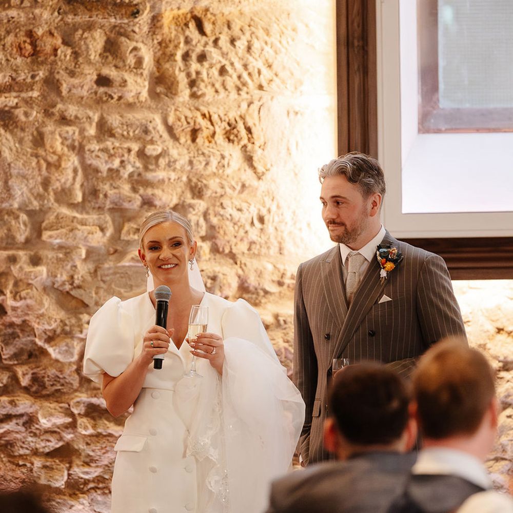 bride-in-puff-sleeve-blazer-wedding-dress-reads-wedding-speech