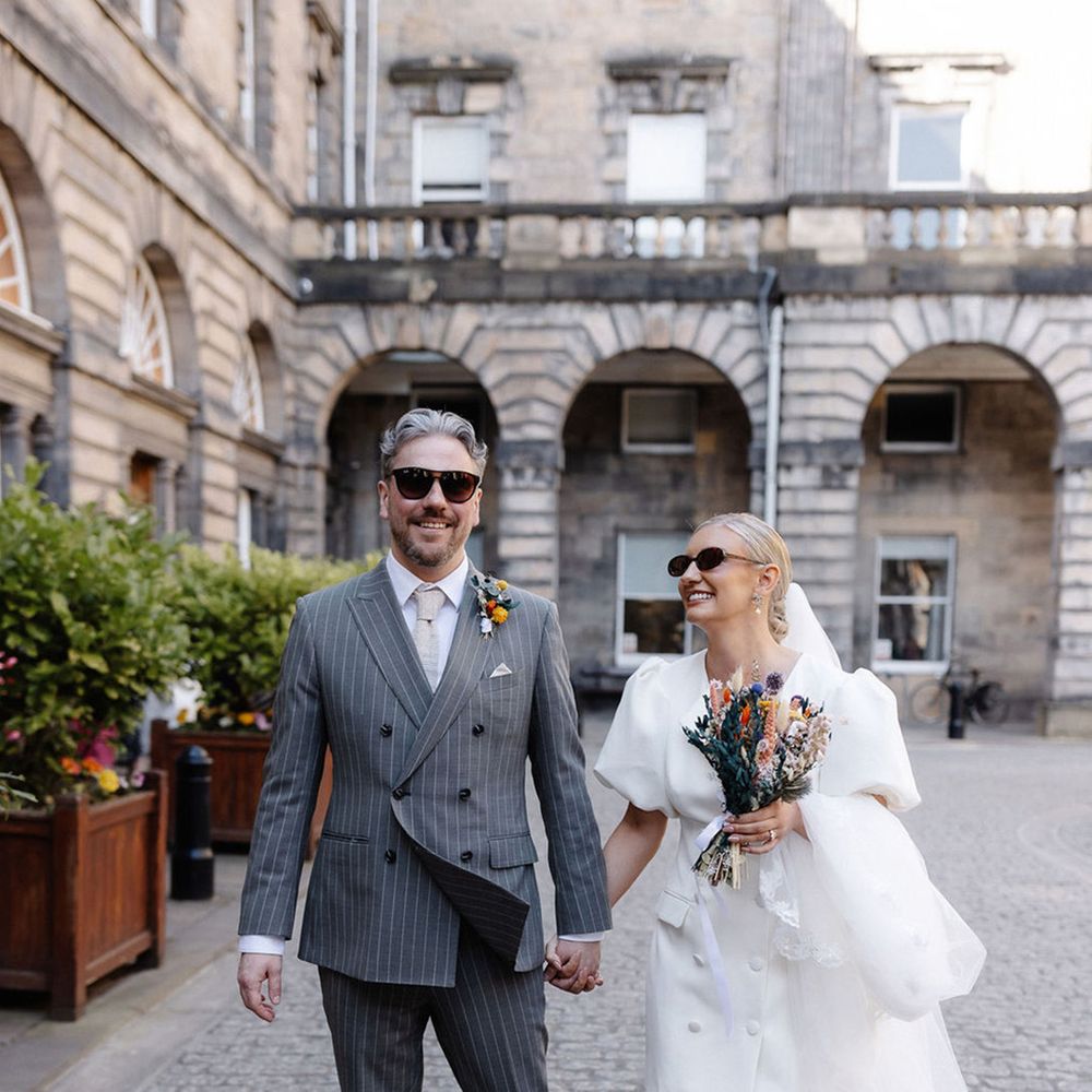 groom-in-grey-pinstripe-suit-with-bride-in-puff-sleeve-wedding-dress