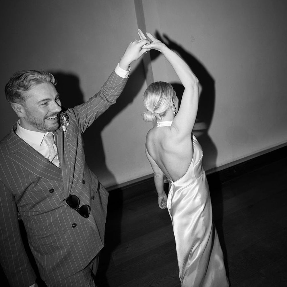 groom-spins-bride-around-for-evening-wedding-photo