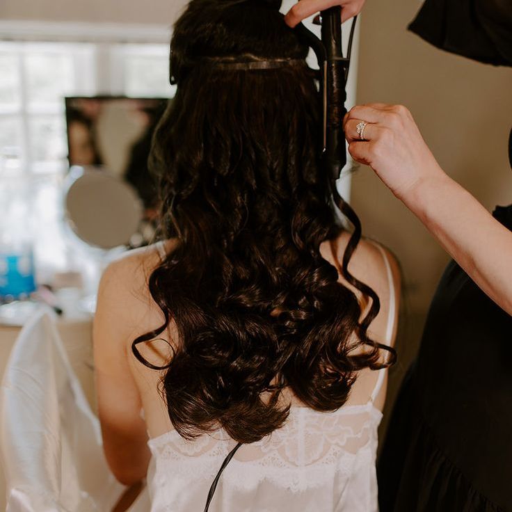 Bride Getting Hair Curled For Wedding Day