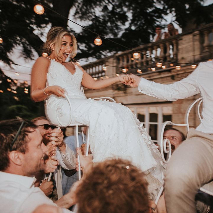 Bride and groom on chairs at the wedding party as part of Jewish tradition