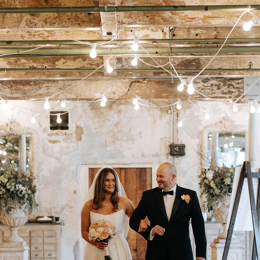 father-of-the-bride-in-black-tuxedo-walks-bride-down-the-aisle