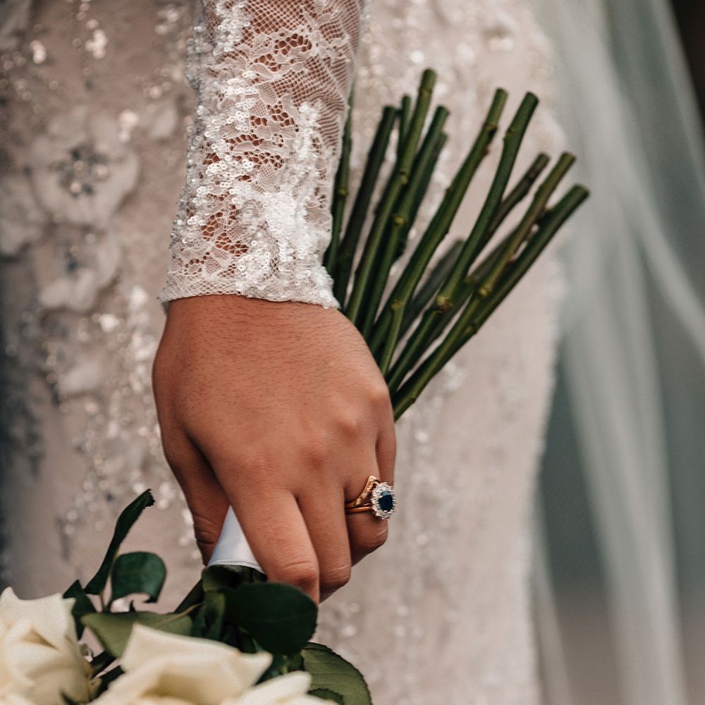 bride-wearing-sapphire-halo-diamond-engagement-ring