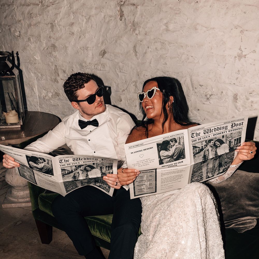 flash-photo-of-bride-and-groom-reading-personalised-wedding-newspaper