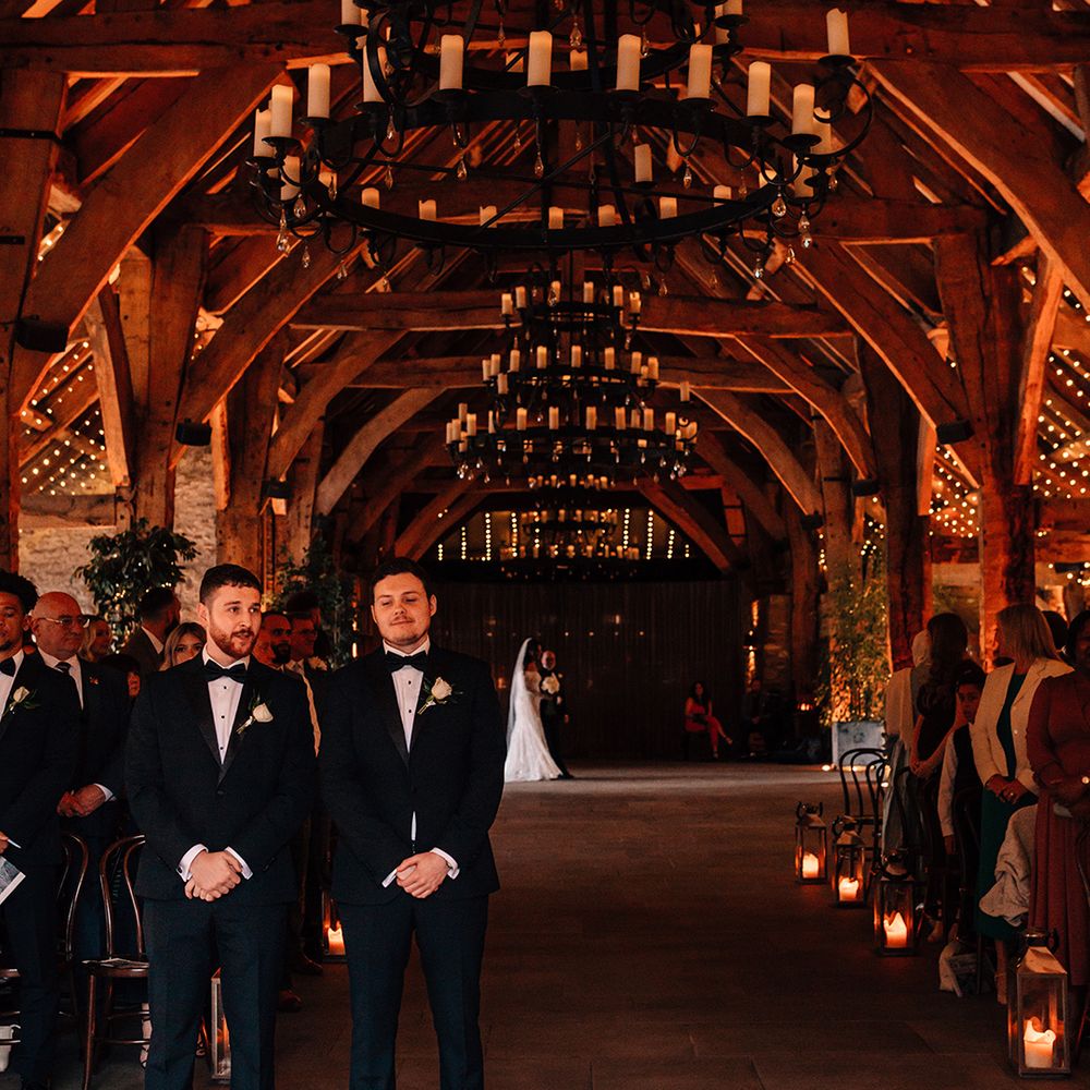 groom-and-best-man-stand-at-barn-wedding-waiting-for-bride
