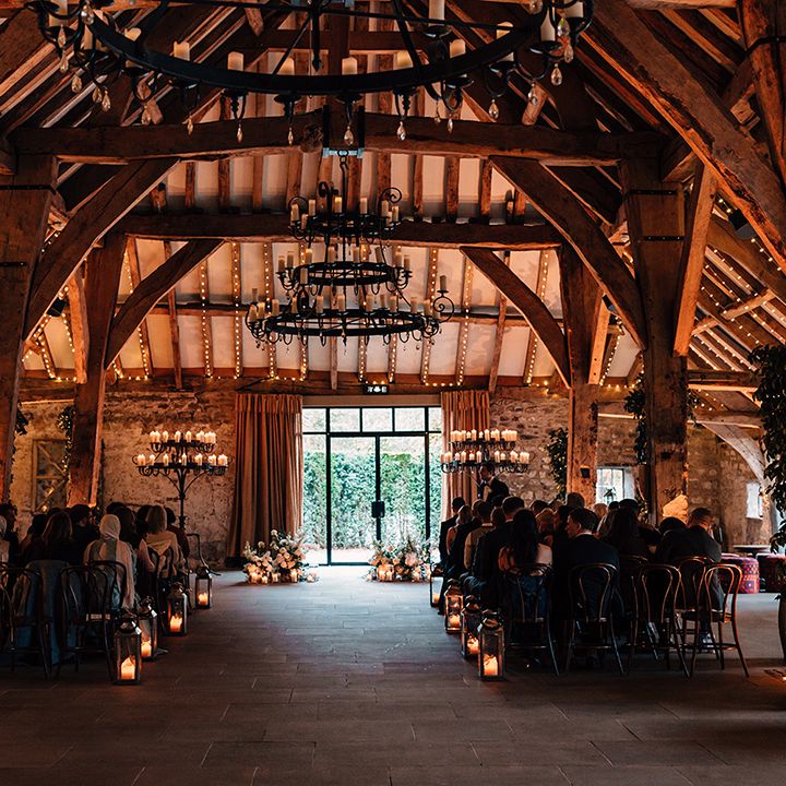 wedding-guests-seated-for-autumnal-wedding-at-tithe-barn