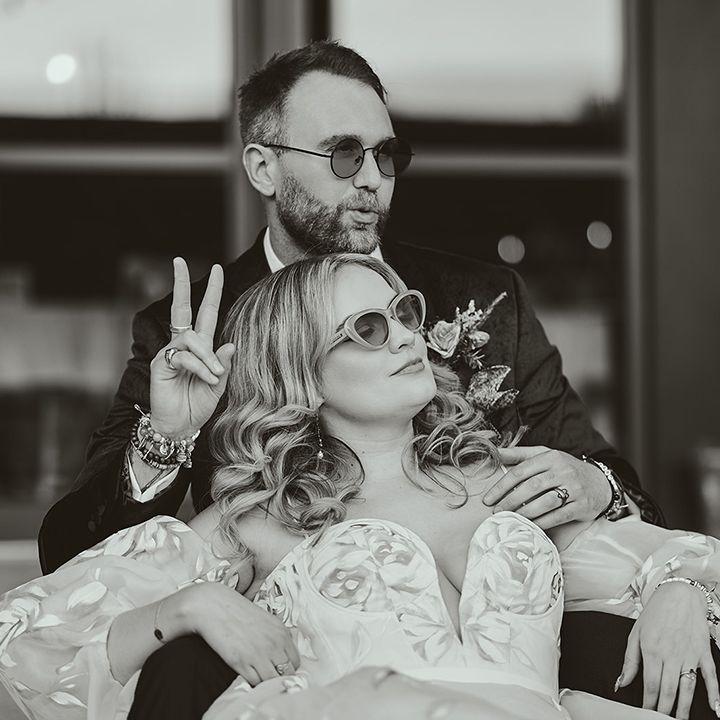 bride-and-groom-pose-together-wearing-sunglasses