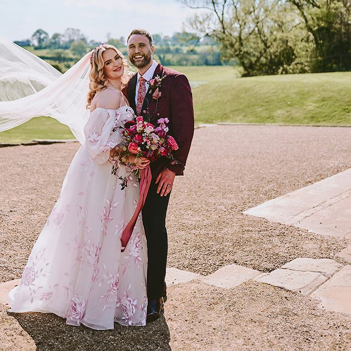 bride-in-custom-pink-flower-wedding-dress-with-groom-in-red-suit