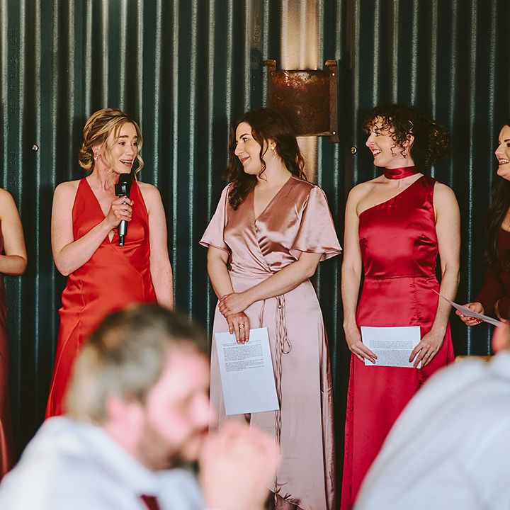bridesmaids-wearing-mismatched-pink-red-bridesmaid-dresses