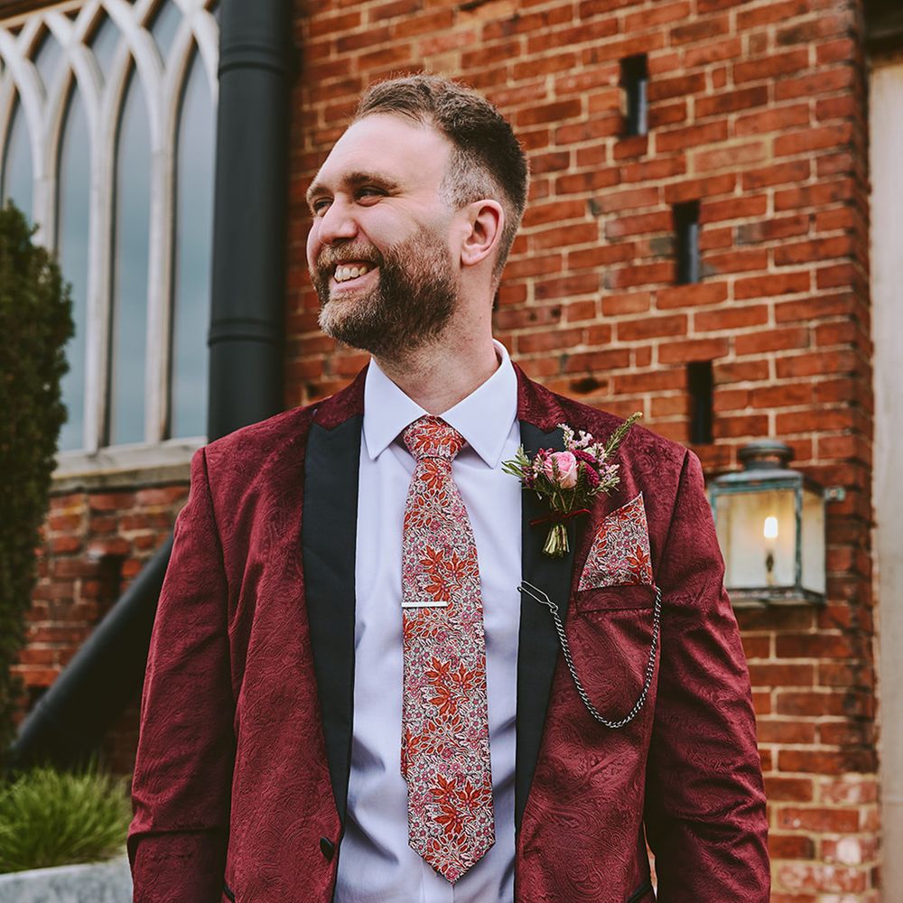 groom-in-red-velvet-tuxedo-with-floral-tie