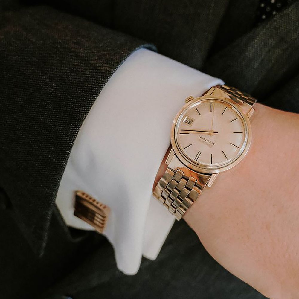Classic gold watch and matching gold cufflink for groom