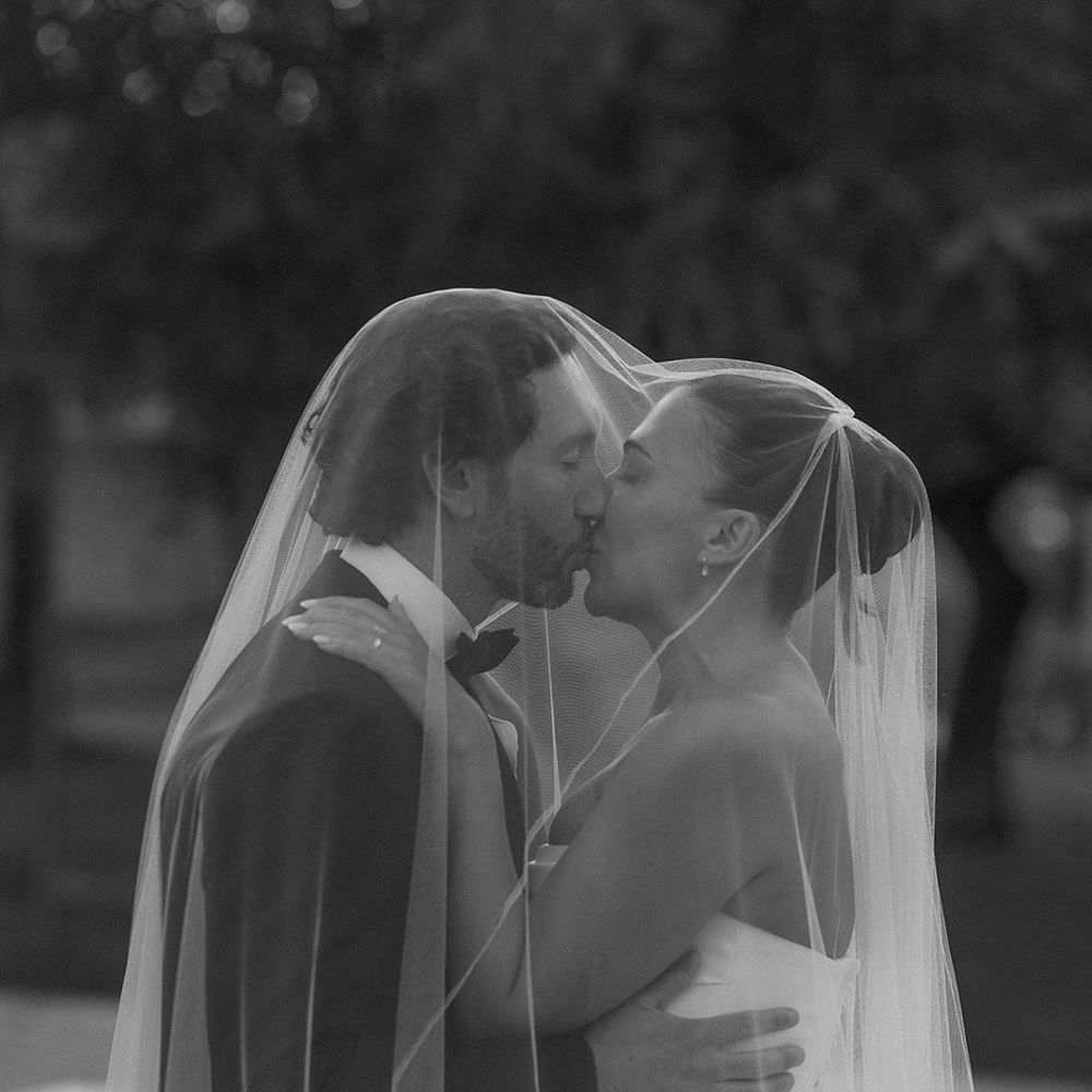 bride-and-groom-kiss-under-wedding-veil