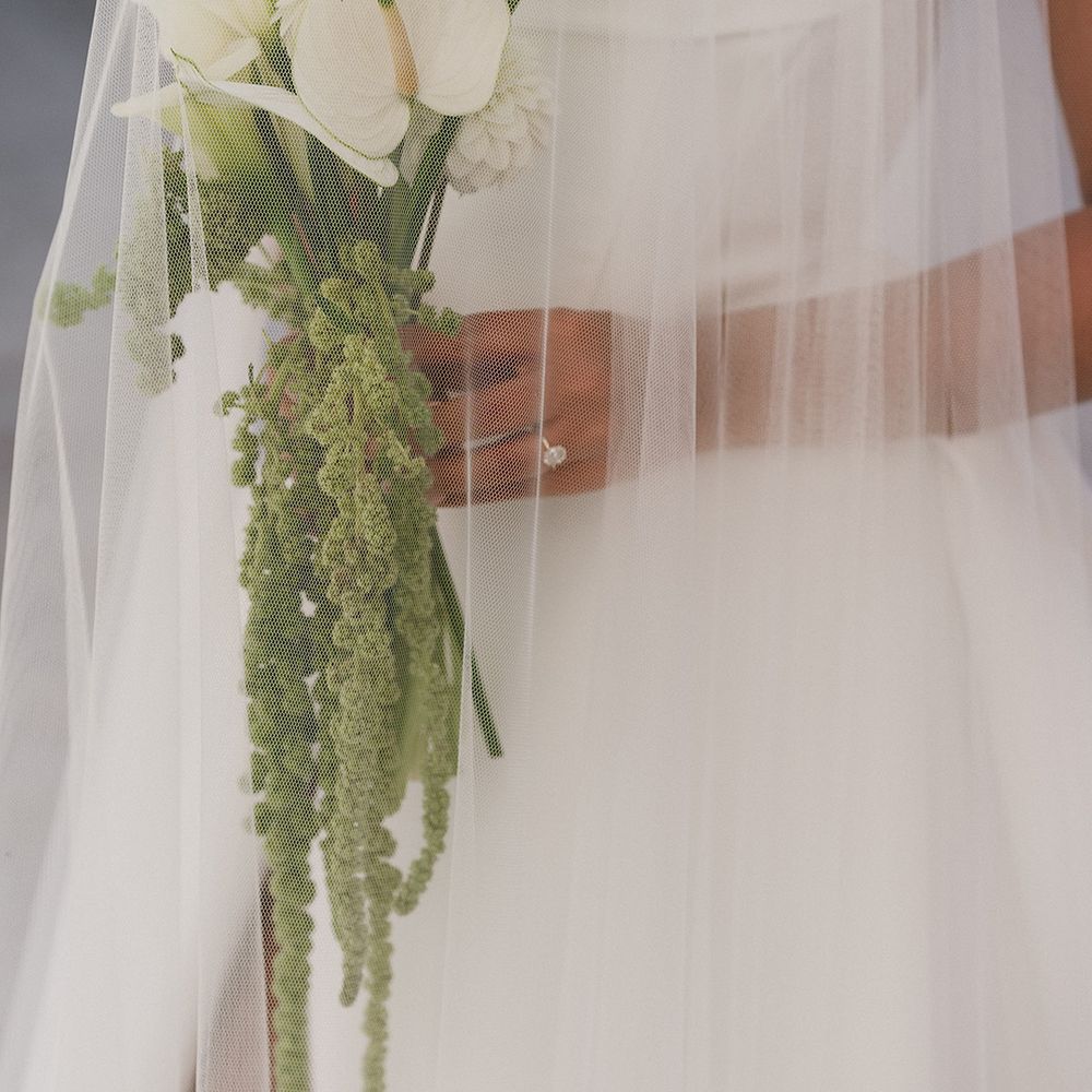bride-holding-white-lily-wedding-bouquet