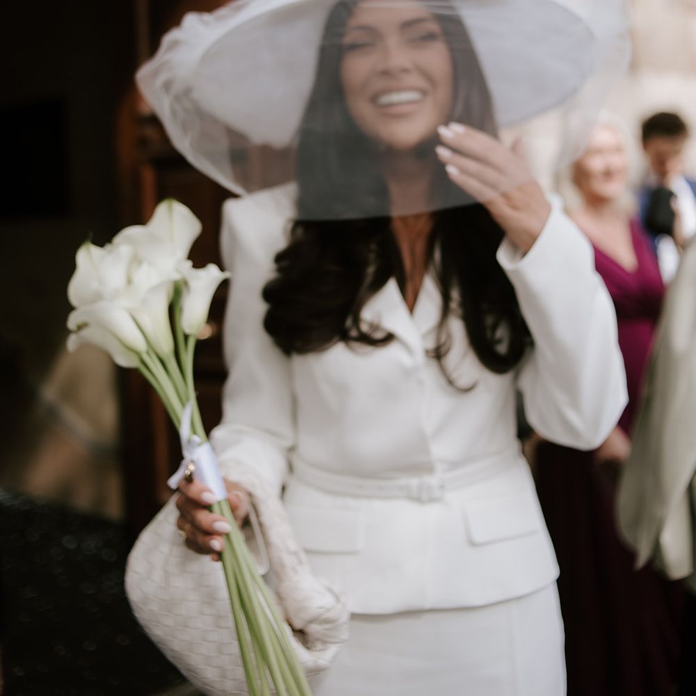 bride-wearing-wide-brimmed-hat-with-veil-for-registry-office-ceremony