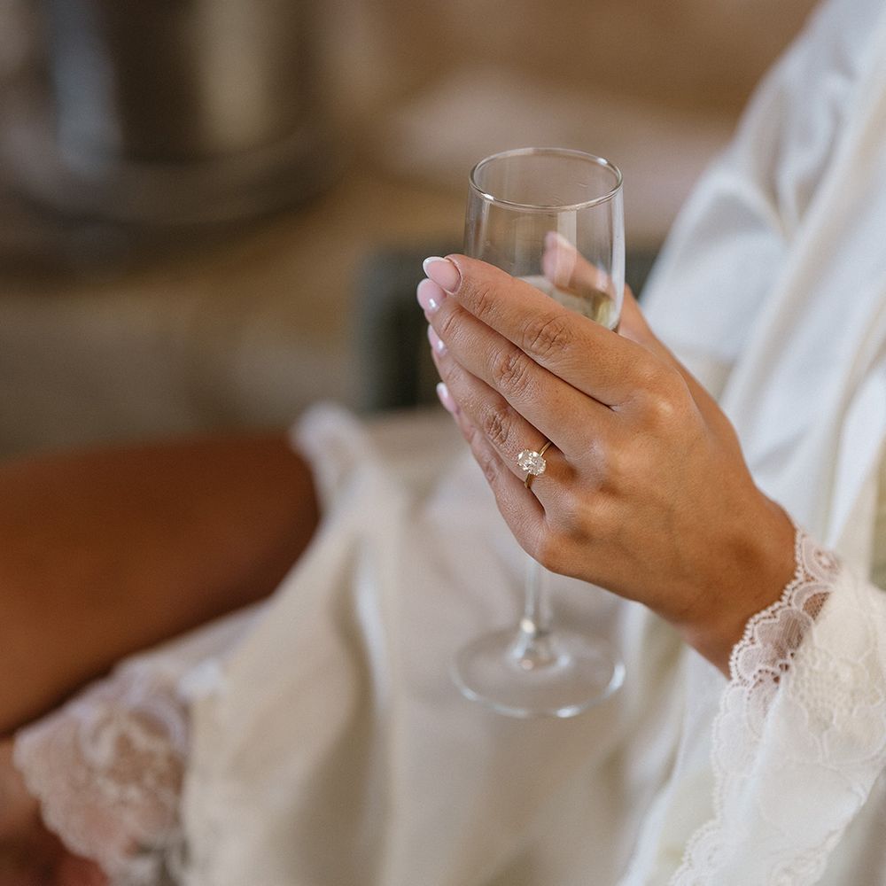 bride-with-oval-diamond-engagement-ring-with-gold-band