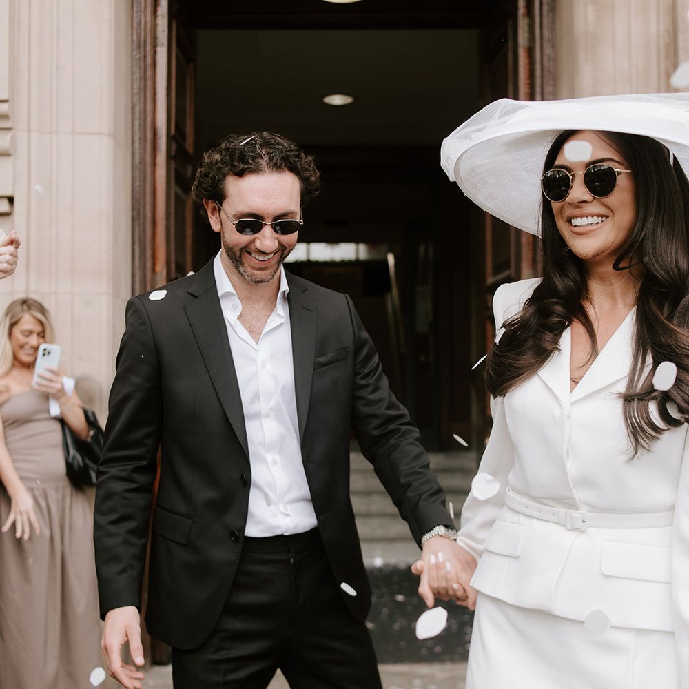 Couple exits their wedding ceremony to confetti thrown by guests