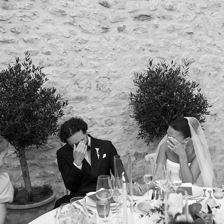 couple-laugh-reacting-to-wedding-speeches