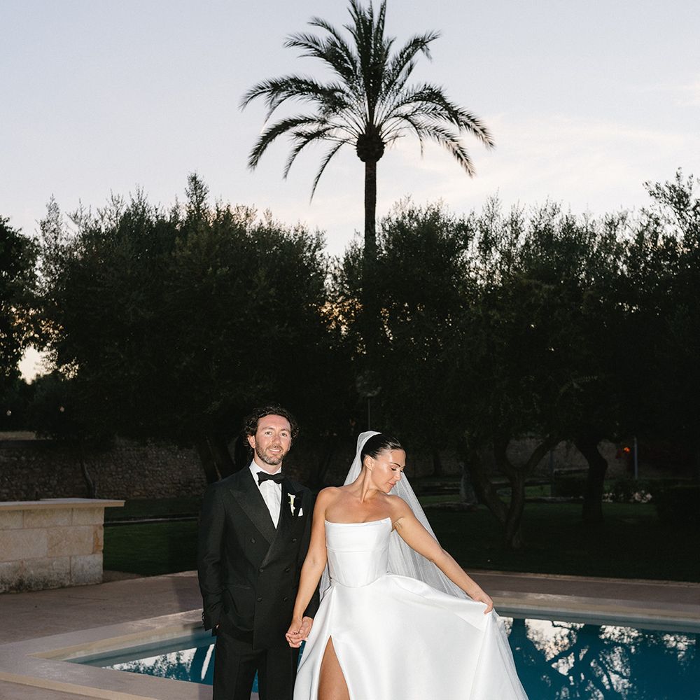 couple-pose-together-by-swimming-pool