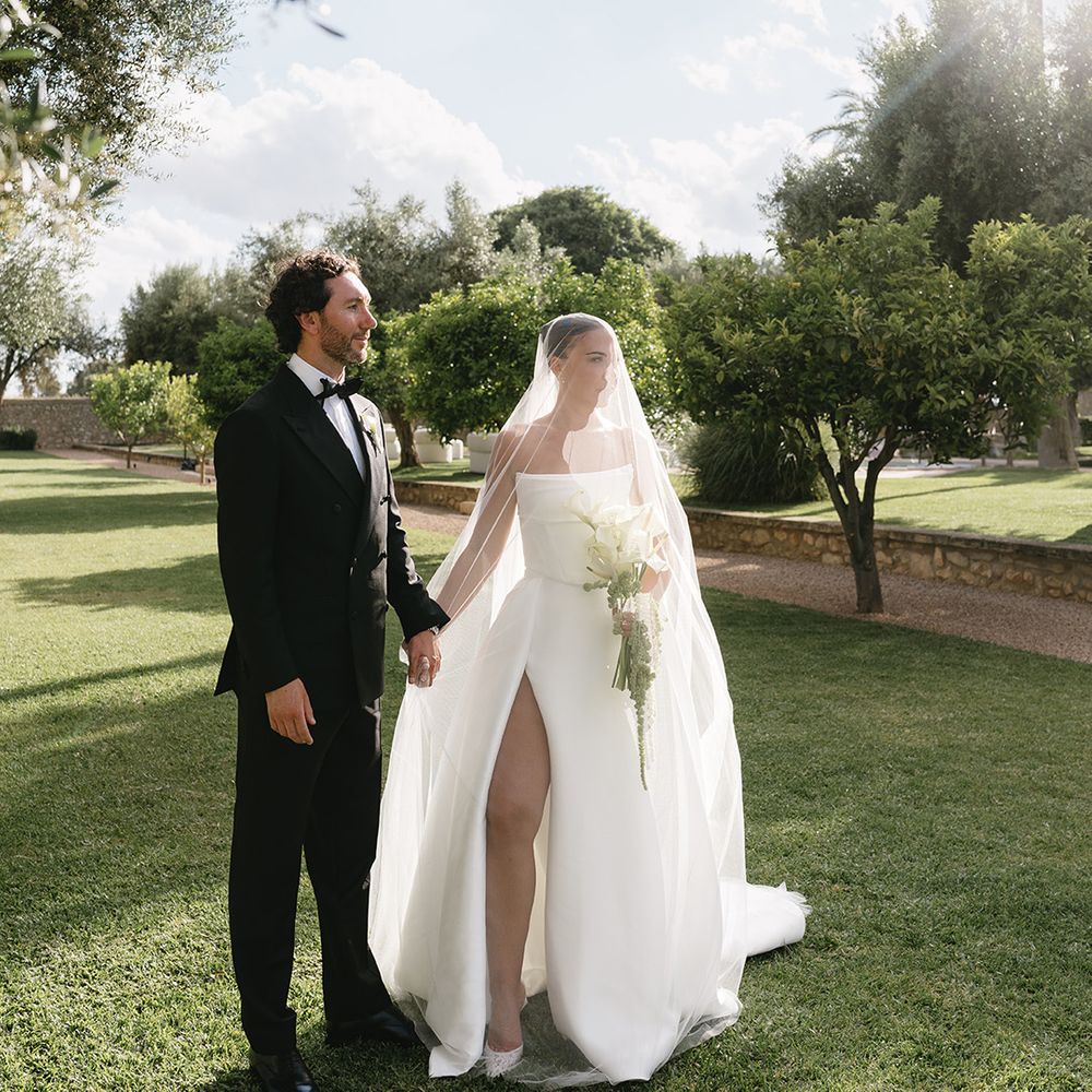 groom-in-black-tux-with-bride-under-veil