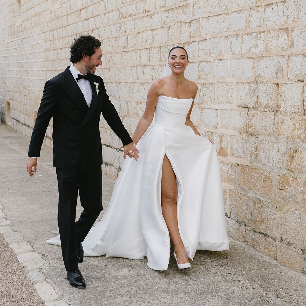 groom-in-black-tuxedo-with-bride-in-corset-wedding-dress-with-front-slit