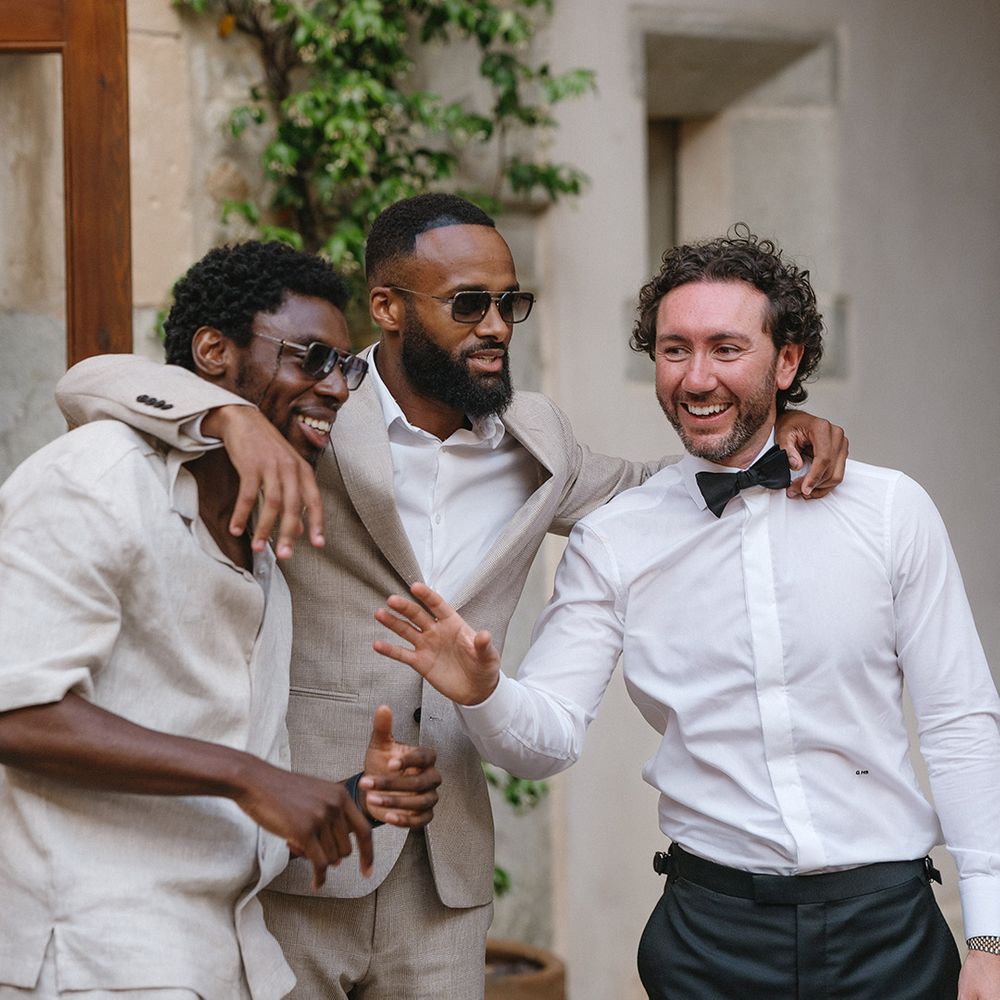 wedding-guests-socialise-at-wedding-breakfast-with-groom