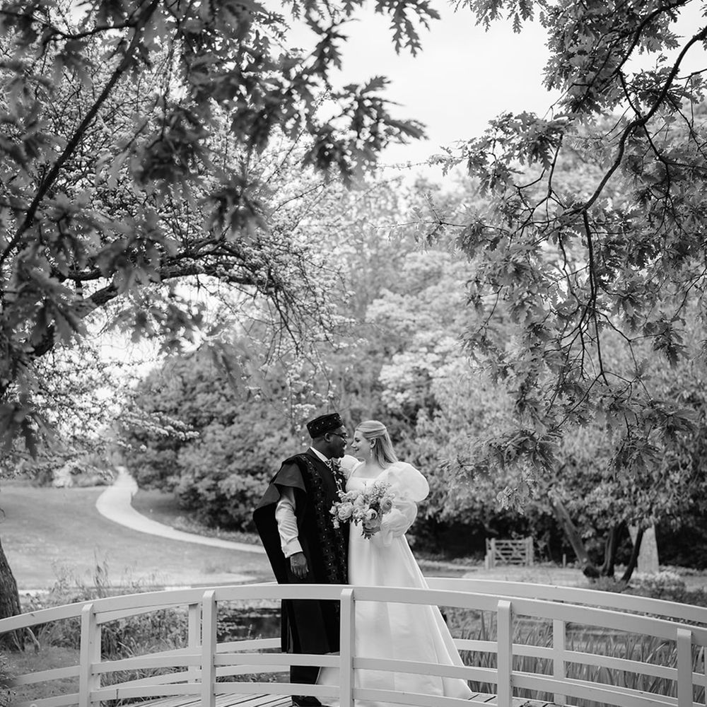 bride-and-groom-on-small-bridge-black-and-white-photo