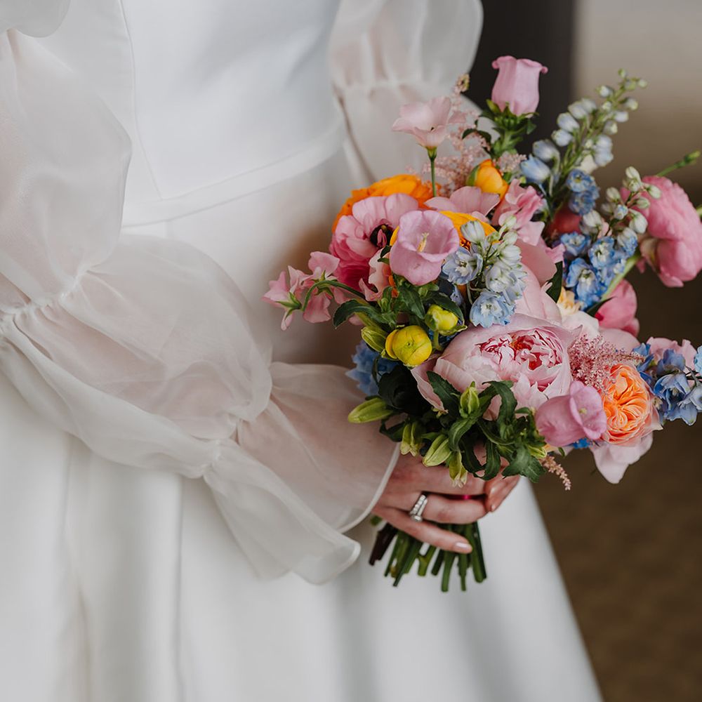 bride-holding-bright-colourful-wedding-bouquet