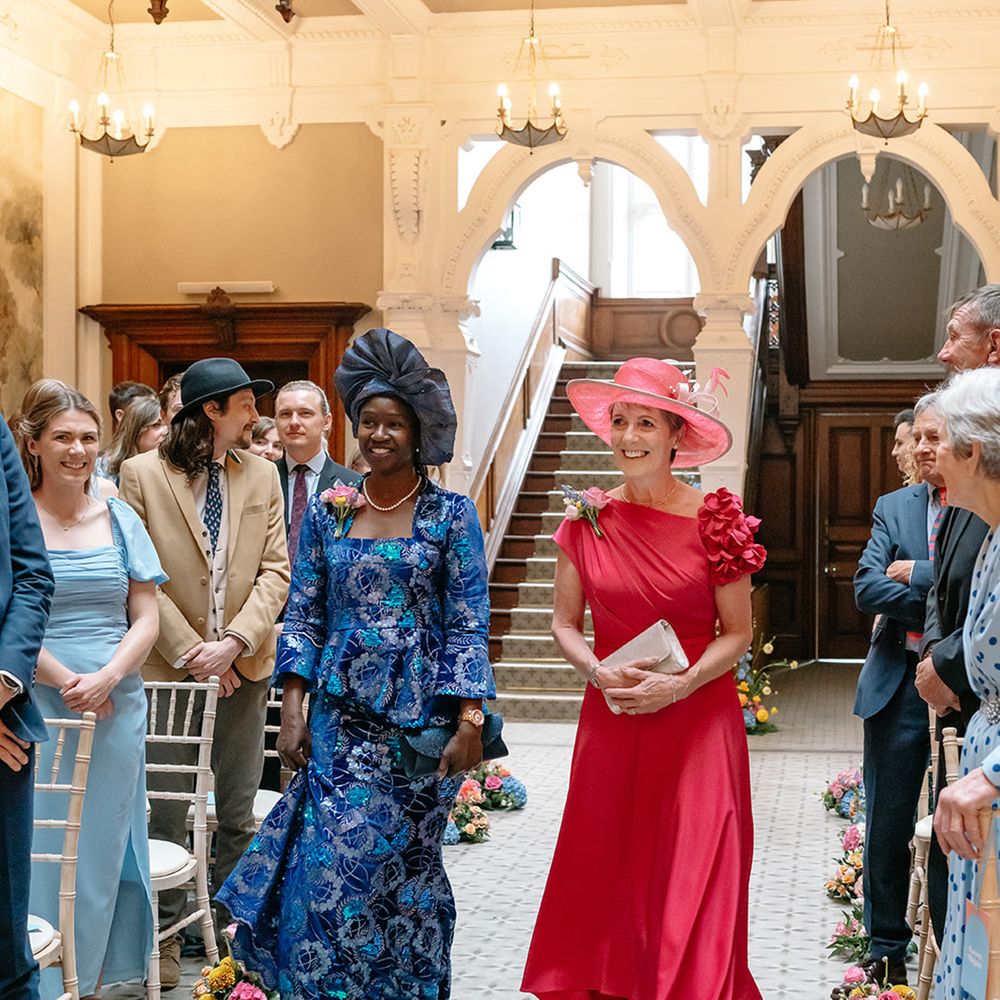 mother-of-the-bride-and-groom-walk-down-the-aisle-together