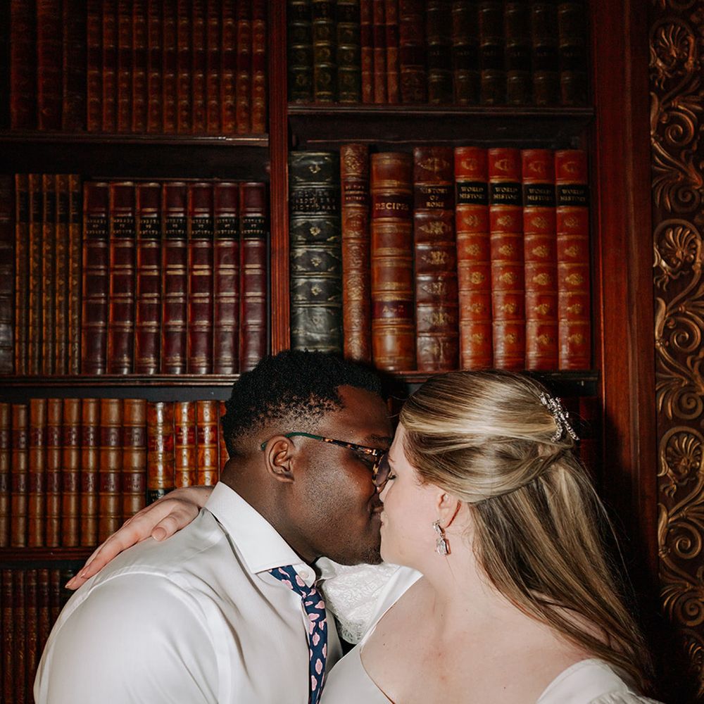 passionate-kiss-between-bride-and-groom-in-library-at-clevedon-hall