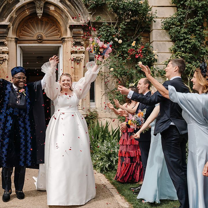 red-confetti-moment-for-couple-walking-out-of-ceremony