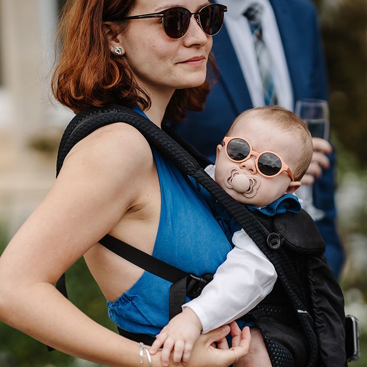 wedding-guest-with-baby-wearing-sunglasses