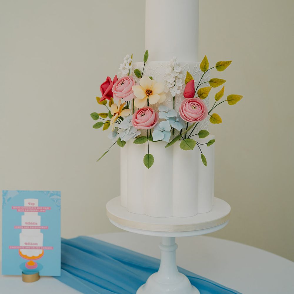white-iced-wedding-cake-with-colourful-flowers