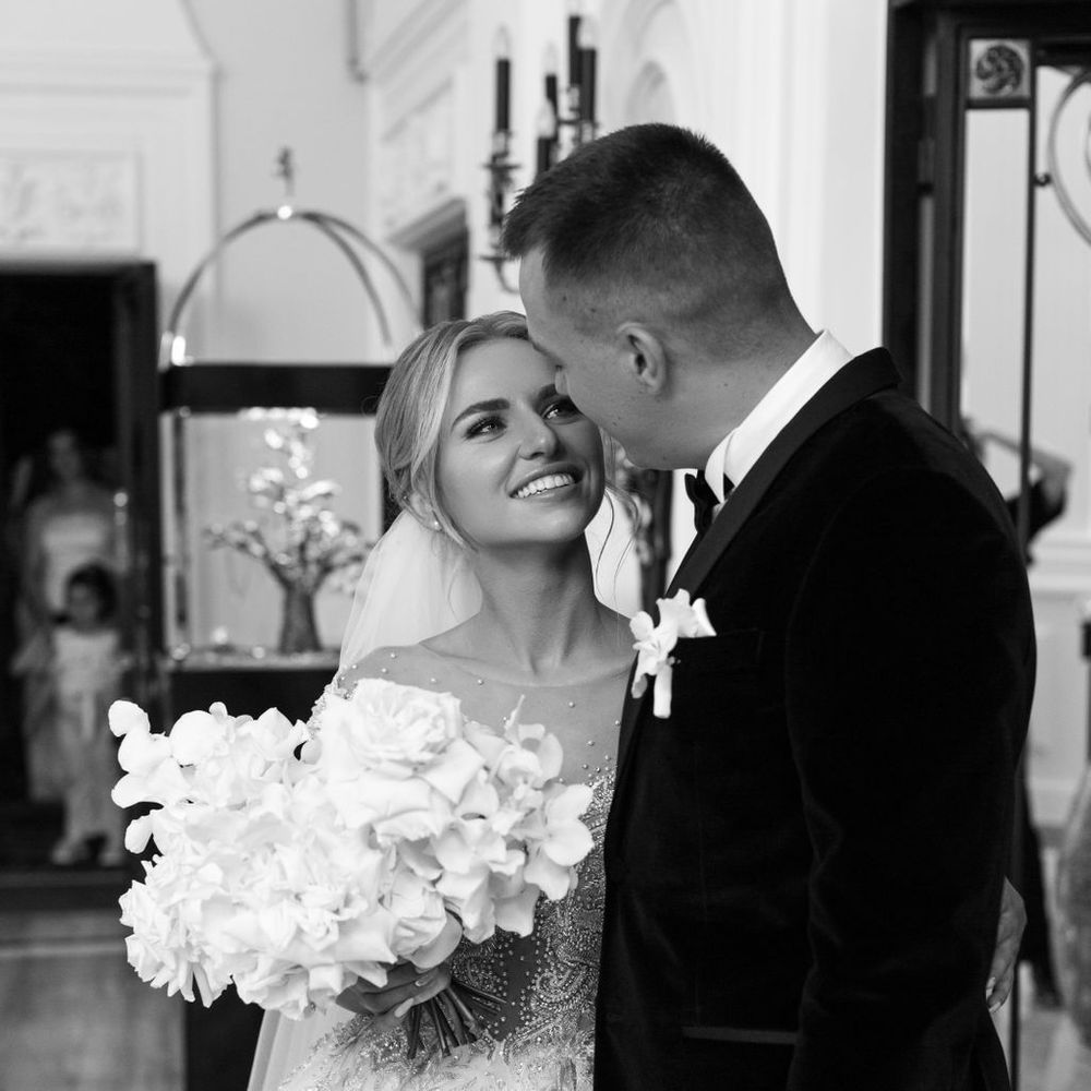 bride-with-white-flower-bouquet-smiling-up-at-groom