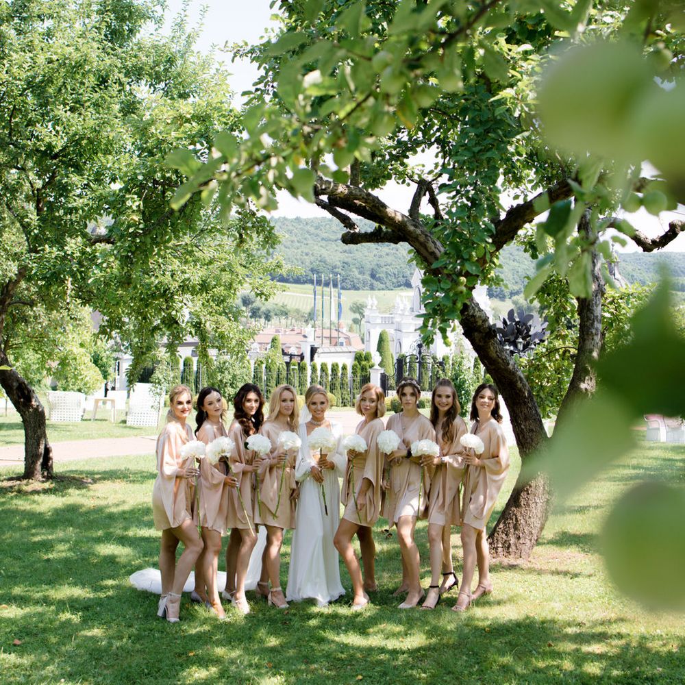 gold-satin-robes-with-bride-at-outdoor-wedding