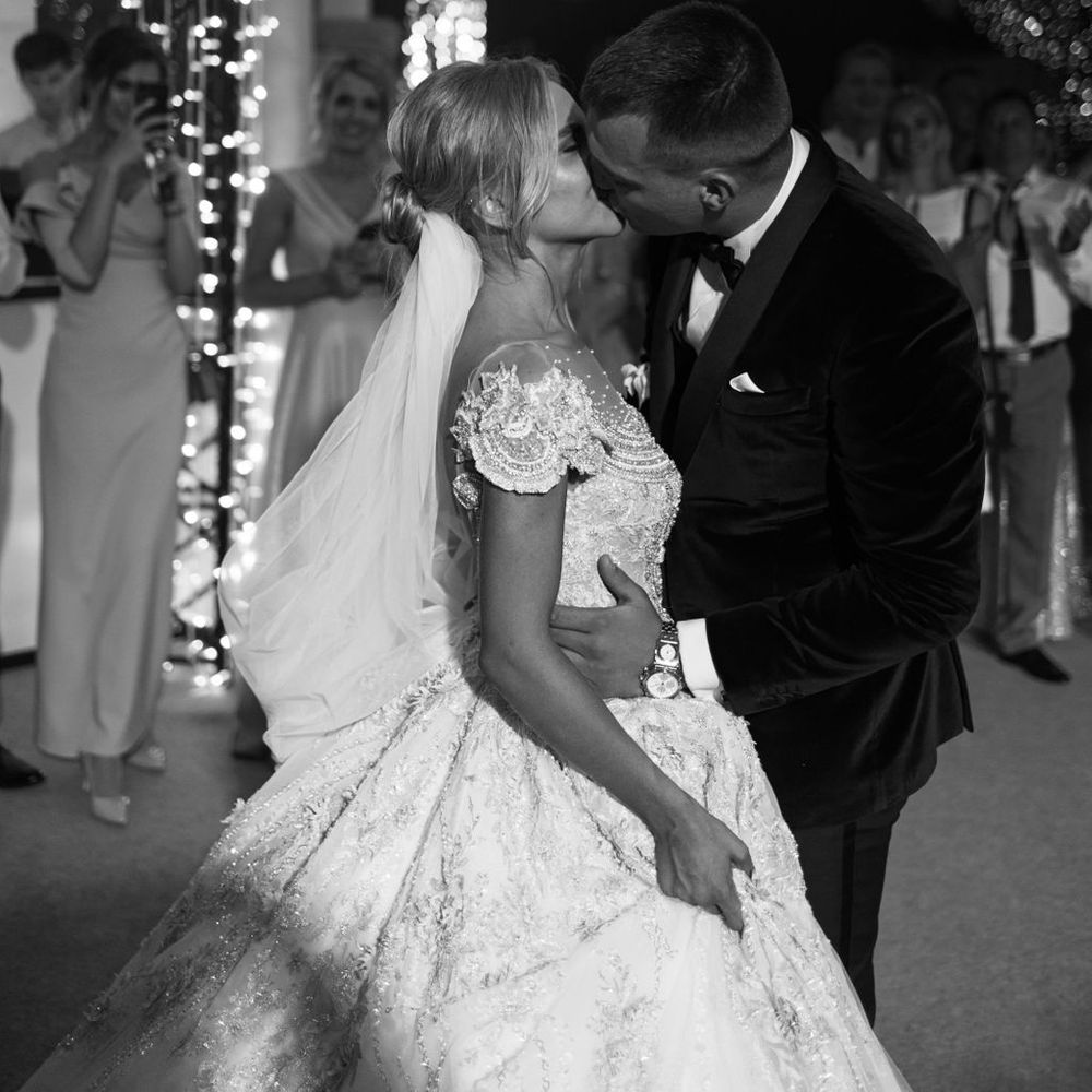 groom-kisses-the-bride-as-they-dance